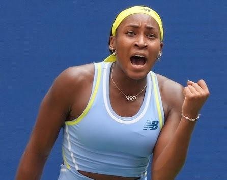Coco Gauff wykonująca potężny serwis tenisowy, z widoczną koncentracją i dynamiką ruchu.